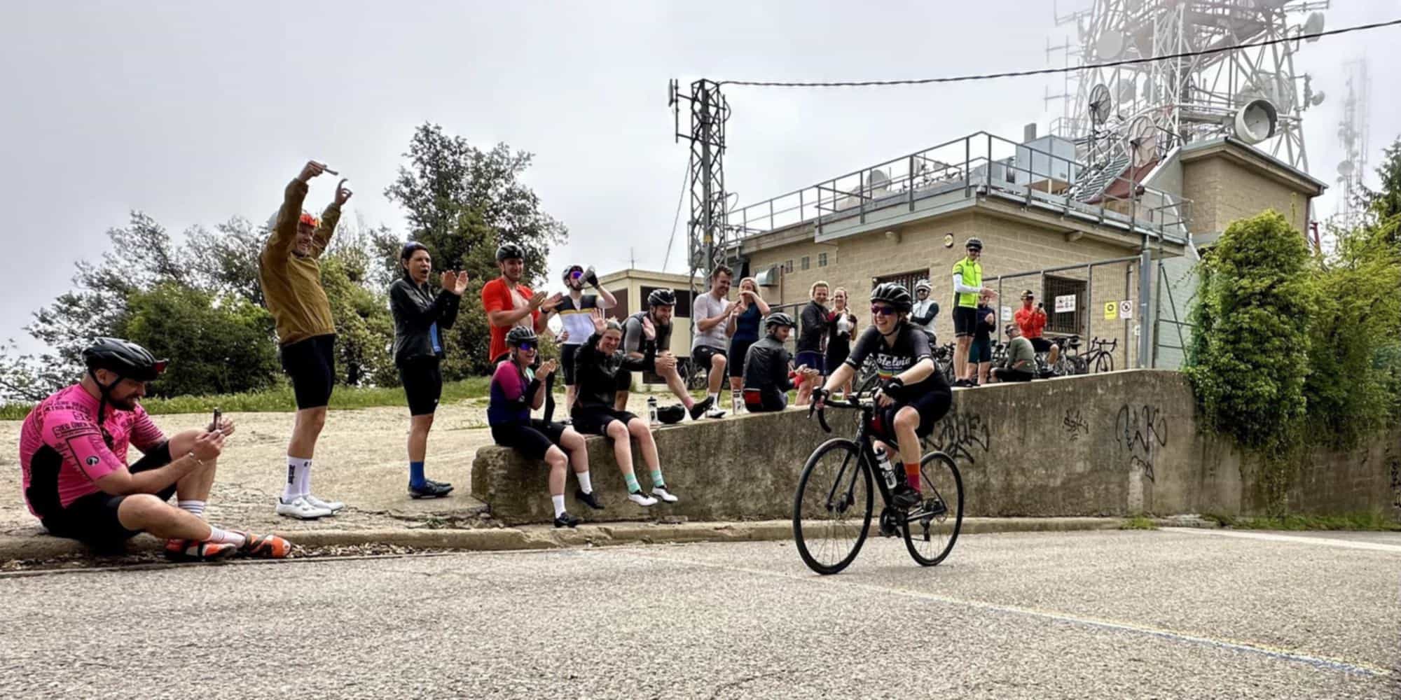 Auster club members celebrating a rider completing the Rocacorba climb